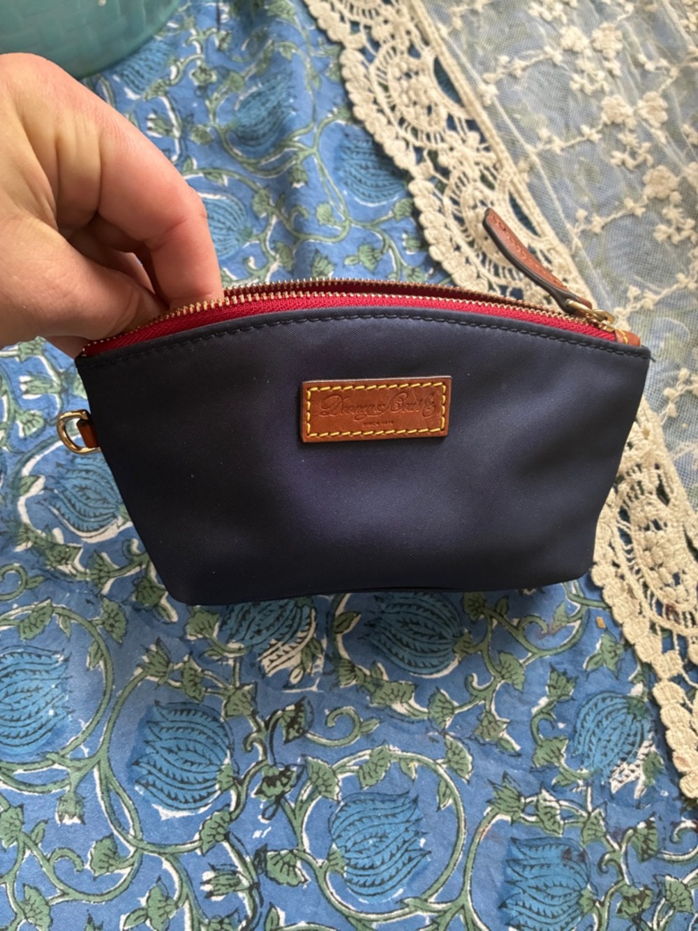 Dooney & Bourke navy pouch with leather accents.